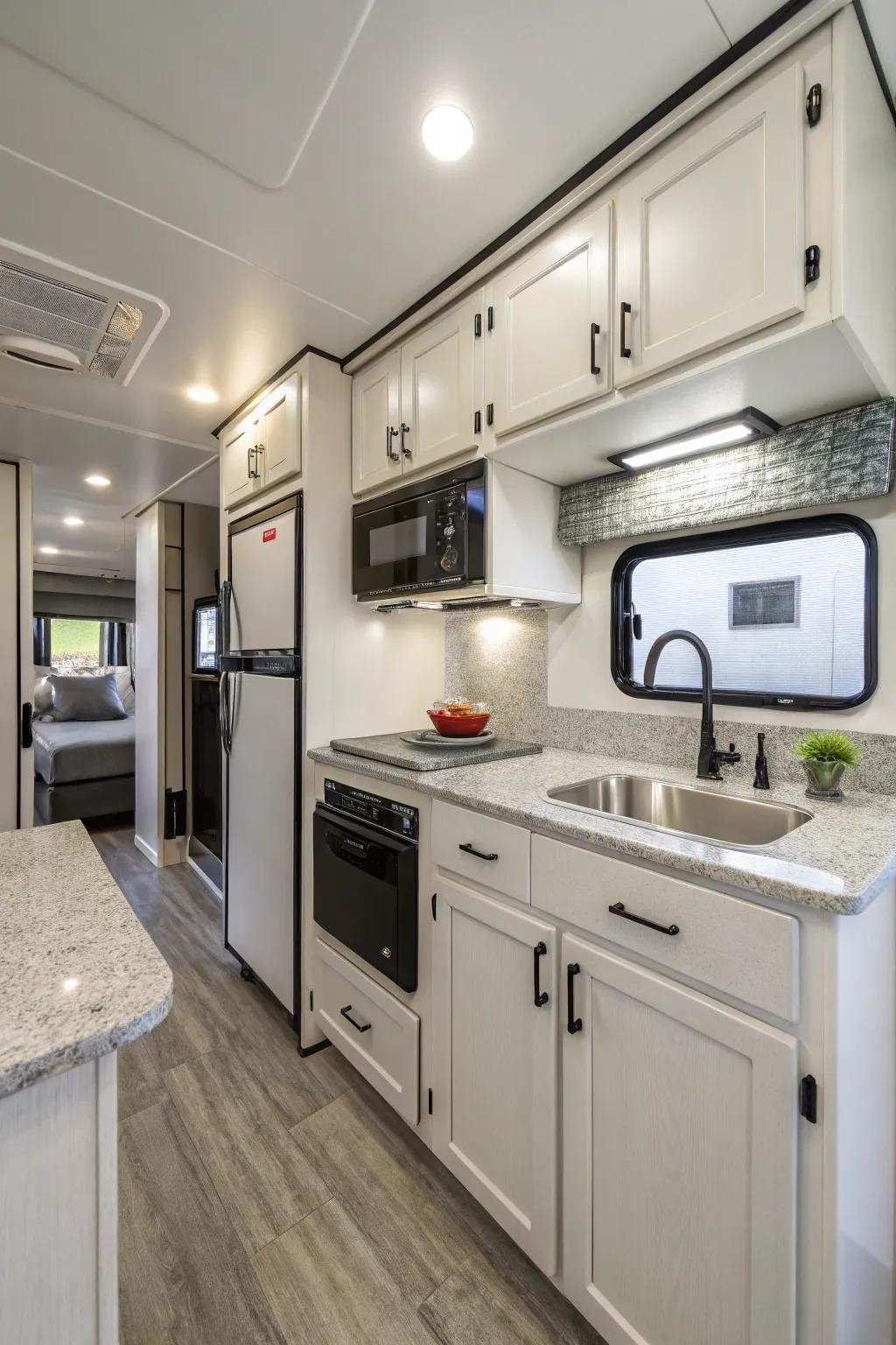 A contemporary recreational vehicle culinary space showcasing streamlined storage solutions and condensed equipment tailored for streamlined food preparation.