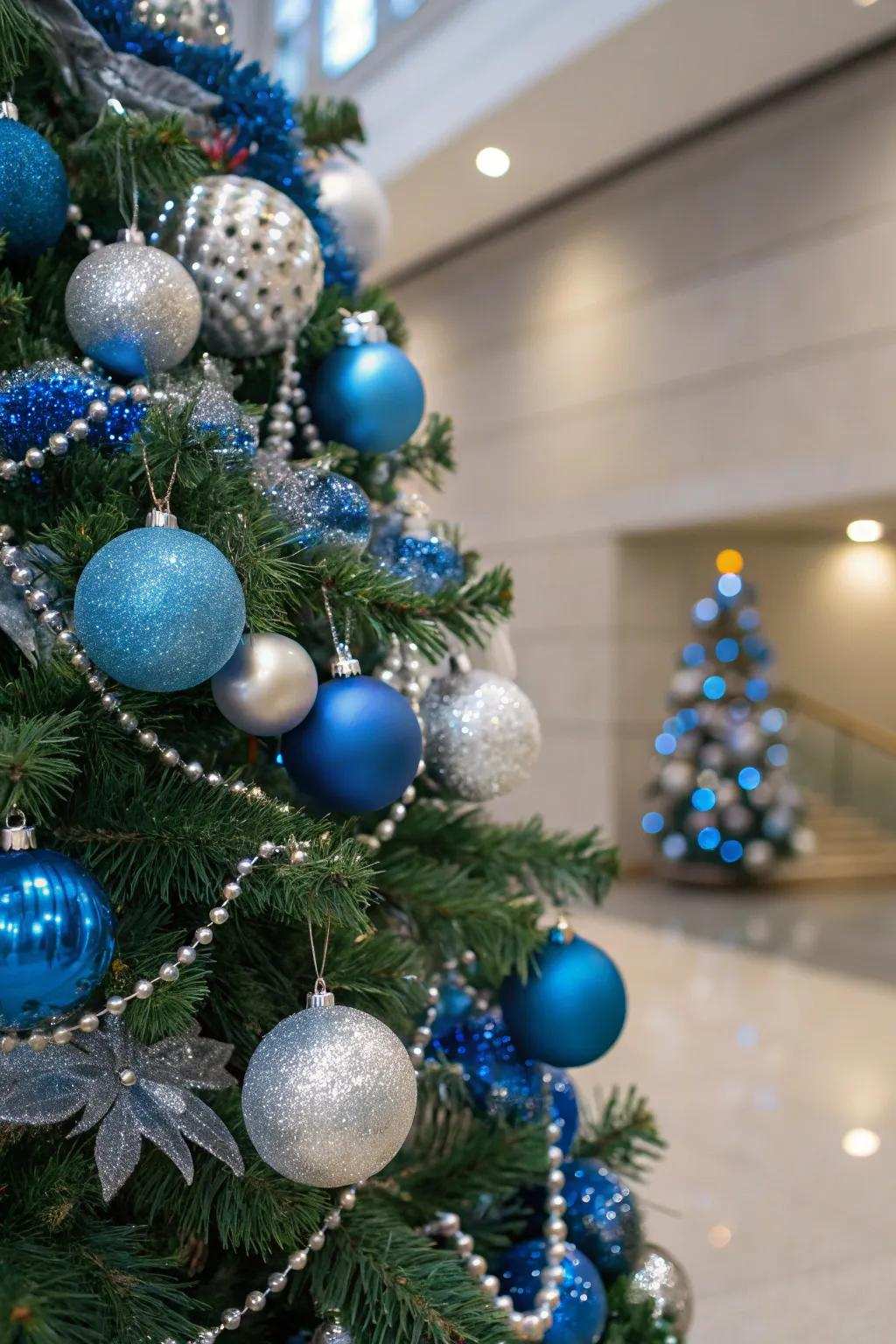 A single-color themed Christmas tree featuring blue and silver decorations.