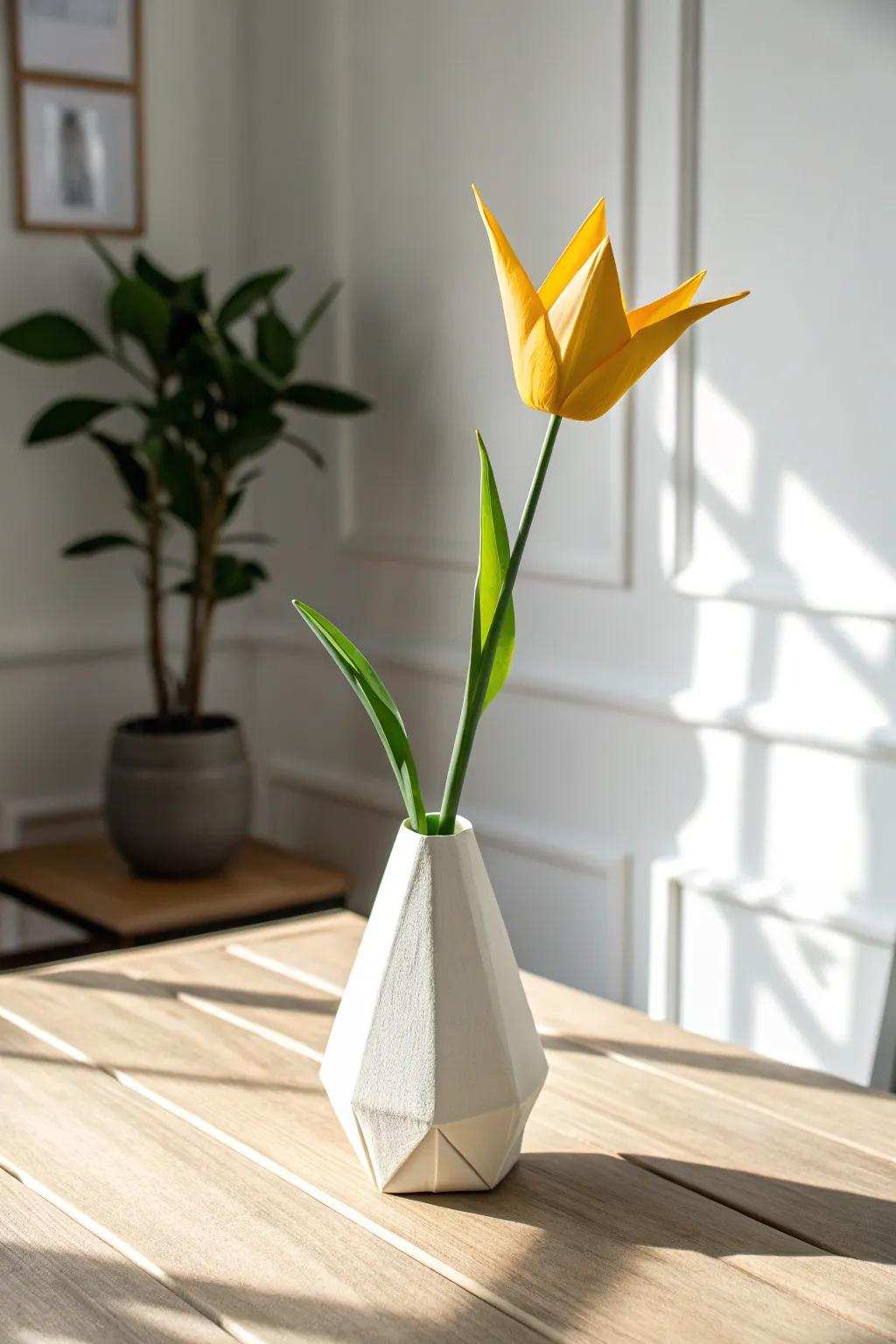 Appreciate the understated beauty and charm of a bright paper-crafted tulip in a handmade vase, bringing an elegant accent to any room.