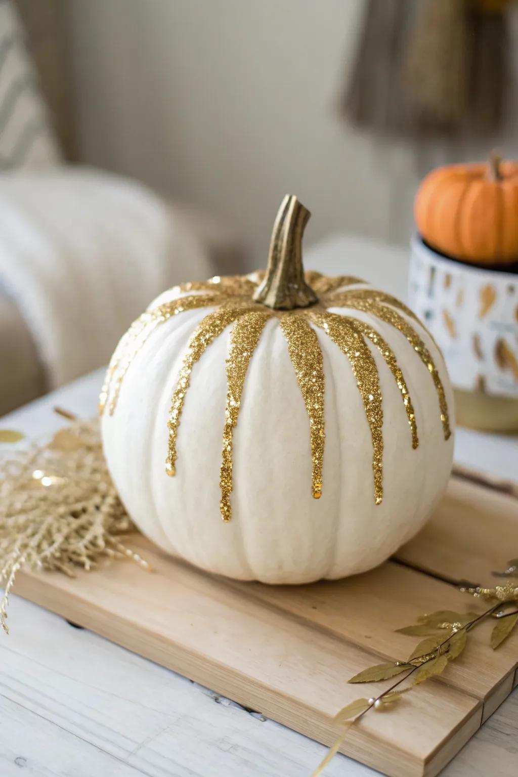 Embrace the art of simplicity with a touch of sparkle: A glitter-dripped pumpkin for a chic autumn centerpiece.