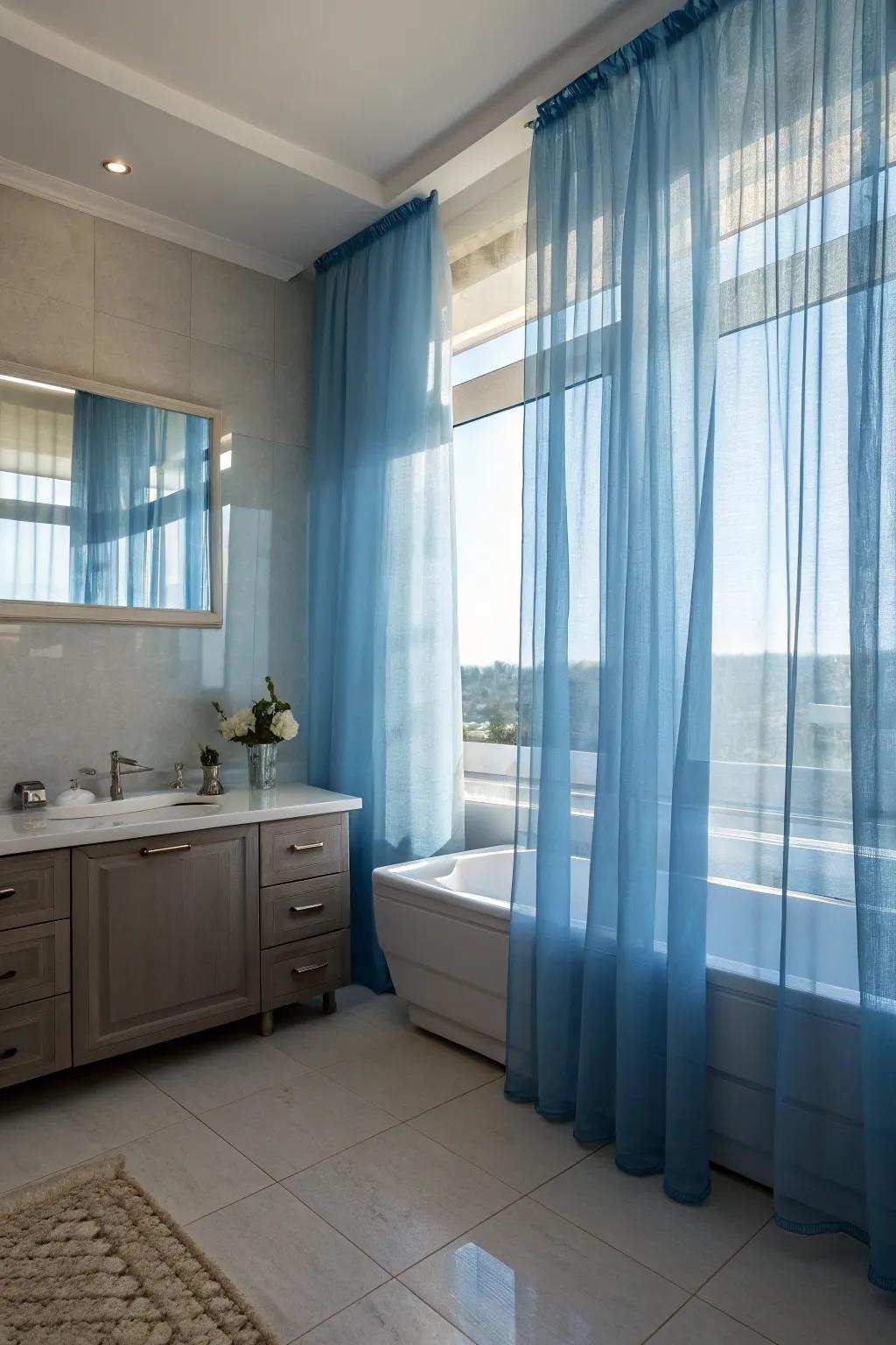Sheer azure window covers provide solitude while establishing a dreamlike, ethereal ambiance.