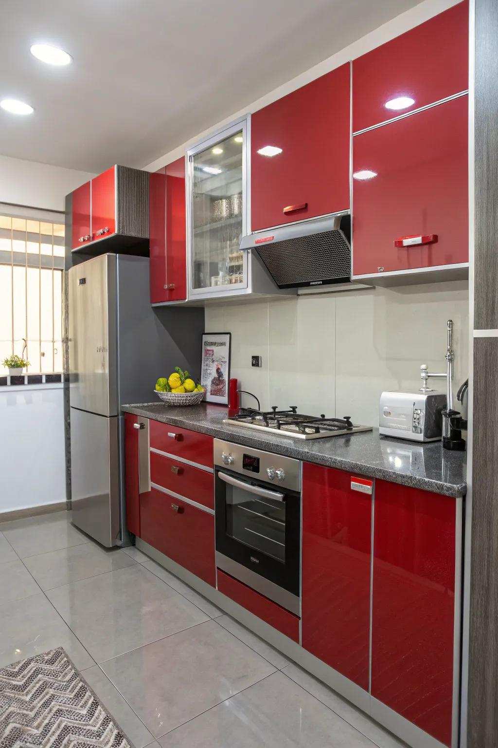 Shiny red and gray cabinets reflecting light to enhance a small kitchen.